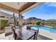 Inviting pool area featuring covered patio, desert landscaping, and views of the nearby mountains at 26560 N 115Th St, Scottsdale, AZ 85255