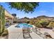 Inviting blue pool with desert landscaping and patio seating creates a serene outdoor retreat at 26560 N 115Th St, Scottsdale, AZ 85255