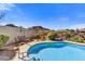 Inviting blue pool with desert landscaping creates a serene outdoor retreat at 26560 N 115Th St, Scottsdale, AZ 85255