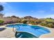 Inviting blue pool with desert landscaping and mountain views creates a serene outdoor retreat at 26560 N 115Th St, Scottsdale, AZ 85255