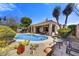 Inviting blue pool with patio seating and desert landscaping creates a serene outdoor retreat at 26560 N 115Th St, Scottsdale, AZ 85255