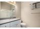 Bathroom featuring quartz countertops, white cabinets, glass shower and a mirror at 295 N Rural Rd # 151, Chandler, AZ 85226