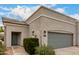 Charming single story home featuring a gray garage door and sidewalk leading to the front entrance at 295 N Rural Rd # 151, Chandler, AZ 85226