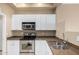 The kitchen features stainless steel appliances and white shaker cabinets at 295 N Rural Rd # 151, Chandler, AZ 85226