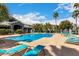 Resort style community pool with lounge chairs, palm trees and shade at 295 N Rural Rd # 151, Chandler, AZ 85226