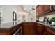 Beautiful bar area with dark wood cabinets, granite countertops, and wine fridge at 3020 E Rockledge Rd, Phoenix, AZ 85048