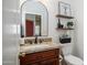 Updated powder room features granite counters and framed mirror at 3020 E Rockledge Rd, Phoenix, AZ 85048