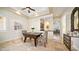 Cozy dining area featuring a modern table, stylish chairs, decorative mirror and easy access to the kitchen at 3020 E Rockledge Rd, Phoenix, AZ 85048