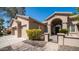 Close up of charming home with arched entry, small front yard with gate and attached garage on a sunny day at 3020 E Rockledge Rd, Phoenix, AZ 85048