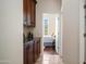 Inviting hallway with beautiful wood cabinets that leads into sunlit bedroom at 3020 E Rockledge Rd, Phoenix, AZ 85048