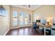 Well-lit home office featuring hardwood floors, neutral paint, double doors, and a ceiling fan at 3020 E Rockledge Rd, Phoenix, AZ 85048