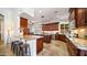 Spacious kitchen featuring a breakfast bar, wood cabinets, and stainless steel appliances at 3020 E Rockledge Rd, Phoenix, AZ 85048