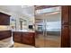 Kitchen featuring stainless steel refrigerator, dark wood cabinets, and granite countertops at 3020 E Rockledge Rd, Phoenix, AZ 85048