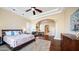 Large main bedroom featuring hardwood floors, plantation shutters, a fireplace, and trey ceilings at 3020 E Rockledge Rd, Phoenix, AZ 85048