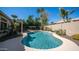 Backyard with a sparkling pool surrounded by lush landscaping and a covered pergola, perfect for outdoor enjoyment at 3020 E Rockledge Rd, Phoenix, AZ 85048