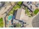 A detailed shot of a large private back yard with a rock-lined pool, patio, and lush green foliage at 3524 E Derringer Way, Gilbert, AZ 85297