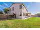 The back of this two-story home features a well maintained lawn and covered patio at 3524 E Derringer Way, Gilbert, AZ 85297