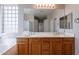 Bright bathroom featuring double sink vanity, large mirror, shower, and a tub offering style and comfort at 3524 E Derringer Way, Gilbert, AZ 85297