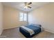 This bedroom has a ceiling fan and neutral walls. A window provides natural light at 3524 E Derringer Way, Gilbert, AZ 85297