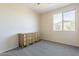 Carpeted bedroom featuring a wooden dresser and a large window with a view of the neighborhood at 3524 E Derringer Way, Gilbert, AZ 85297