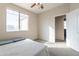 Bright bedroom featuring a ceiling fan, plush carpet, and an open doorway to the en suite bathroom at 3524 E Derringer Way, Gilbert, AZ 85297