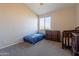 Bedroom featuring a crib, small dresser, and large window for natural light at 3524 E Derringer Way, Gilbert, AZ 85297