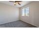 Neutral bedroom featuring a ceiling fan, carpeted floor, and a window at 3524 E Derringer Way, Gilbert, AZ 85297