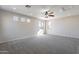 Large bonus room with carpeted floor, ceiling fan, and natural light at 3524 E Derringer Way, Gilbert, AZ 85297