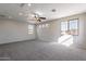 Large bonus room with carpeted floor, ceiling fan, and natural light at 3524 E Derringer Way, Gilbert, AZ 85297