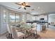 Elegant dining area adjacent to the kitchen with a glass table and modern chairs at 3524 E Derringer Way, Gilbert, AZ 85297