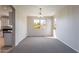 Light-filled dining area with neutral walls, gray carpet and chandelier at 3524 E Derringer Way, Gilbert, AZ 85297