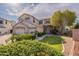 Inviting two-story home with a well-manicured lawn, mature tree, and three-car garage at 3524 E Derringer Way, Gilbert, AZ 85297