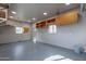 The garage has a gray floor, mounted shelving, and two windows for natural light at 3524 E Derringer Way, Gilbert, AZ 85297