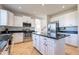 Bright kitchen featuring white cabinets, stainless appliances, black countertops, and a central island at 3524 E Derringer Way, Gilbert, AZ 85297