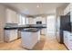 Bright kitchen featuring white cabinets, stainless appliances, black countertops and tile floors at 3524 E Derringer Way, Gilbert, AZ 85297