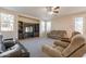 Spacious living room featuring a ceiling fan, lots of natural light, and multiple seating options at 3524 E Derringer Way, Gilbert, AZ 85297