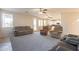 Open-concept living room shows multiple chairs, sofas, tile flooring, and views to the kitchen and backyard at 3524 E Derringer Way, Gilbert, AZ 85297