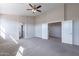 Spacious living room with carpet, featuring neutral walls and ceiling fan, offering ample space and comfort at 3524 E Derringer Way, Gilbert, AZ 85297