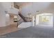 Spacious living area featuring a staircase and stylish lighting fixture at 3524 E Derringer Way, Gilbert, AZ 85297