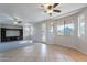 Bright living room featuring tile floors, neutral walls, and ceiling fan, bathed in natural light from the windows at 3524 E Derringer Way, Gilbert, AZ 85297