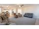 Open-concept living room featuring tile flooring, multiple seating options, and kitchen access at 3524 E Derringer Way, Gilbert, AZ 85297