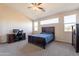 Large main bedroom with a vaulted ceiling, ceiling fan and natural light from multiple windows at 3524 E Derringer Way, Gilbert, AZ 85297