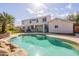 Backyard pool featuring a waterfall, palm trees, and a view of the home at 3524 E Derringer Way, Gilbert, AZ 85297