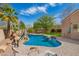 Swimming pool featuring a rock waterfall, basketball hoop, and lounge chairs, for outdoor living at 3562 E Harvard Ct, Gilbert, AZ 85234