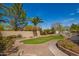 Beautiful backyard with green lawn, stone accents, and mature trees, ideal for relaxing and entertaining at 3562 E Harvard Ct, Gilbert, AZ 85234