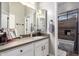 Bathroom featuring a mirrored medicine cabinet, white cabinetry, and a separate toilet and shower room at 3562 E Harvard Ct, Gilbert, AZ 85234