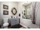 Stylish powder room with a modern vanity, decorative mirror, and unique decor at 3562 E Harvard Ct, Gilbert, AZ 85234