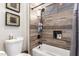 Modern bathroom features wood-look tile shower with built-in niche and black fixtures at 3562 E Harvard Ct, Gilbert, AZ 85234