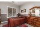 Cozy bedroom with traditional furniture, including a wooden dresser and framed artwork at 3562 E Harvard Ct, Gilbert, AZ 85234