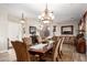 Elegant dining area with a chandelier, fireplace, and seating for six at 3562 E Harvard Ct, Gilbert, AZ 85234